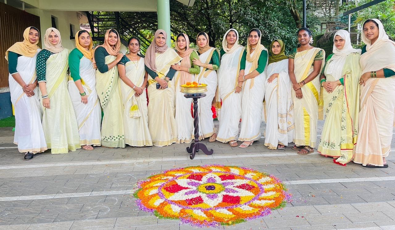 Onam celebration with floral pookalam carpet and traditional attire